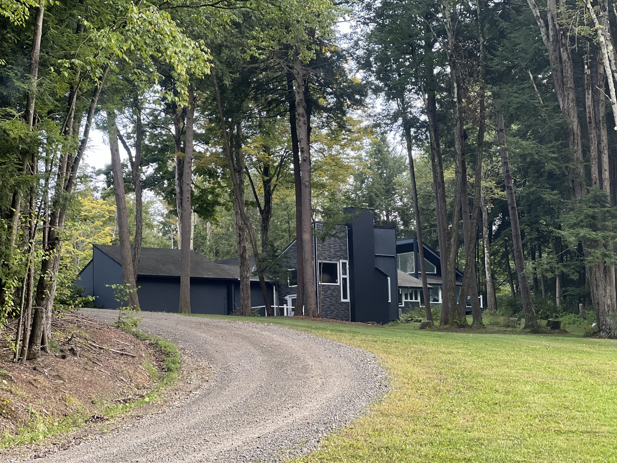 A curved gravel driveway leading up to a house